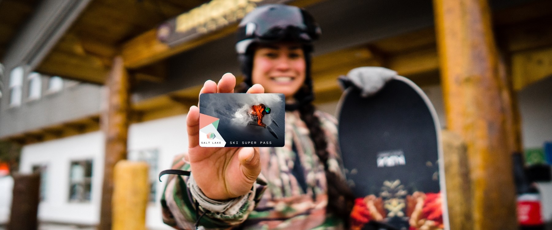 Snowboarder Holding Ski Super Pass